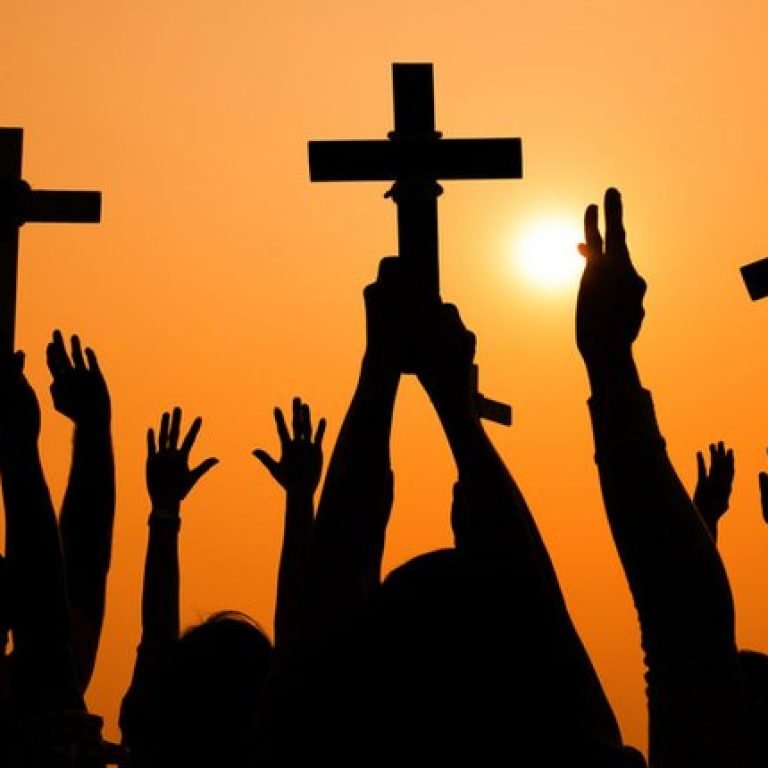 silhouette-of-cross-held-up-at-sunset-on-shutterstock-800x430